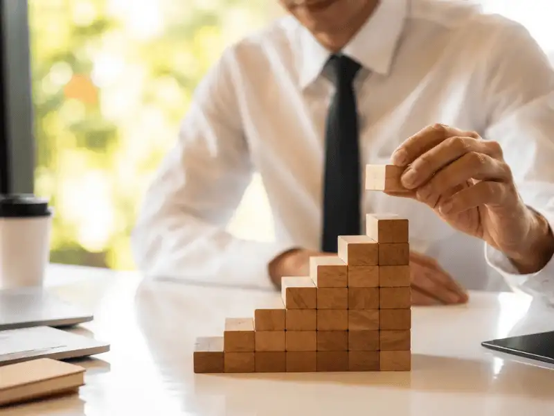 Professional building financial growth strategy with planning blocks representing long-term insurance planning.