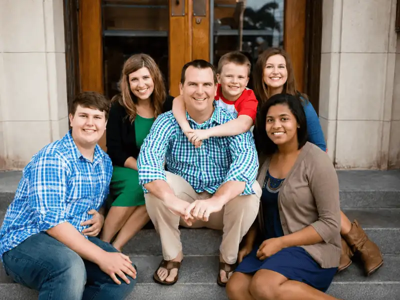 Smiling family together outdoors representing affordable family health insurance coverage.