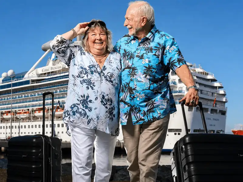 Happy senior couple preparing for a cruise vacation with travel insurance protection.